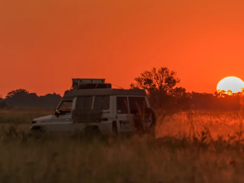 Panorama of jeep driving home at sunset