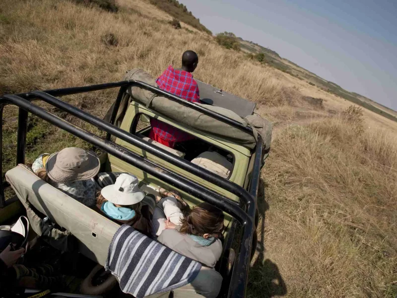 People in safari truck
